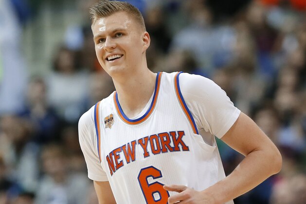 New York Knicks' Kristaps Porzingis (6) of Latvia jogs up court smiling during an NBA basketball game against the Dallas Mavericks on Wednesday, Jan. 25, 2017, in Dallas. (AP Photo/Tony Gutierrez)