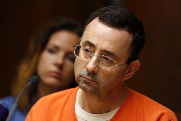 Former Michigan State University and USA Gymnastics doctor Larry Nassar is seen in the 55th District Court where Judge Donald Allen Jr. bound him over on June 23, 2017 in Mason, Michigan to stand trial on 12 counts of first-degree criminal sexual conduct. / AFP PHOTO / JEFF KOWALSKY        (Photo credit should read JEFF KOWALSKY/AFP/Getty Images)