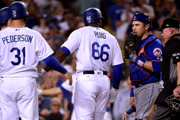 LOS ANGELES, CA - JUNE 21: Travis d'Arnaud #18 of the New York Mets talks to Yasiel Puig #66 of the Los Angeles Dodgers as he crosses the plate after his three run homerun to take a 5-1 lead during the fourth inning at Dodger Stadium on June 21, 2017 in Los Angeles, California. (Photo by Harry How/Getty Images) LOS ANGELES, CA - JUNE 21: Travis d'Arnaud #18 of the New York Mets talks to Yasiel Puig #66 of the Los Angeles Dodgers as he crosses the plate after his three run homerun to take a 5-1 lead during the fourth inning at Dodger Stadium on June 21, 2017 in Los Angeles, California. (Photo by Harry How/Getty Images)
