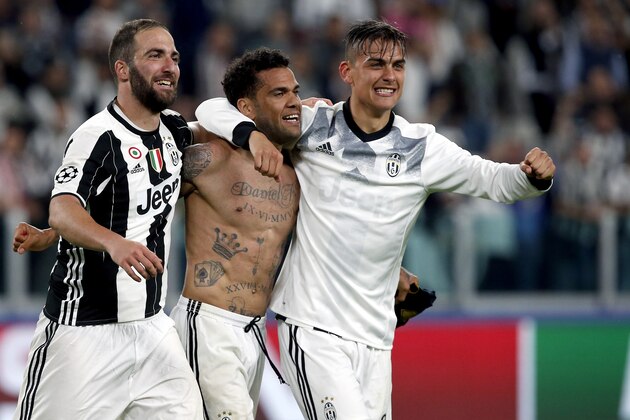 FILE - In this Tuesday, May 9, 2017 file photo, from left, Juventus' Gonzalo Higuain, Dani Alves and Paulo Dybala celebrate after the Champions League semi final second leg soccer match between Juventus and Monaco in Turin, Italy. Juventus keeps on breaking records. And it set another one on Sunday when it clinched an unprecedented sixth successive Serie A title, with one game to spare, following a victory over Crotone. It is the first time since Serie A was founded in 1929 that a club has won six straight titles. (AP Photo/Antonio Calanni, File)