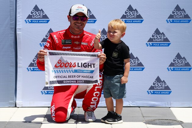 SONOMA, CA - JUNE 24:  Kyle Larson, driver of the #42 Target Chevrolet, and his son, Owen, pose with the Coors Light Pole Award after qualifying for the Monster Energy NASCAR Cup Series Toyota/Save Mart 350 at Sonoma Raceway on June 24, 2017 in Sonoma, California.  (Photo by Sarah Crabill/Getty Images)