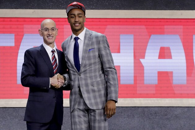 John Collins poses with NBA Commissioner Adam Silver after being selected by the Atlanta Hawks as the 19th pick overall during the NBA basketball draft, Thursday, June 22, 2017, in New York. (AP Photo/Frank Franklin II)