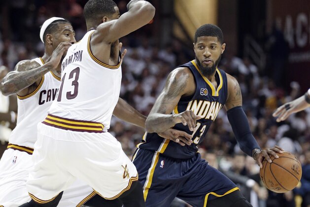 Indiana Pacers' Paul George, right, drives past Cleveland Cavaliers' Iman Shumpert, left, and Tristan Thompson in the second half in Game 2 of a first-round NBA basketball playoff series, Monday, April 17, 2017, in Cleveland. The Cavaliers won 117-111. (AP Photo/Tony Dejak)