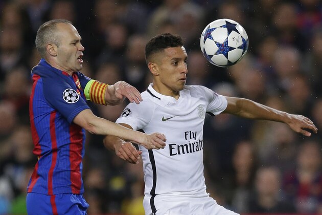 Barcelona's Andres Iniesta, left, challenges for the ball with PSG's Marquinhos during the Champion's League round of 16, second leg soccer match between FC Barcelona and Paris Saint Germain at the Camp Nou stadium in Barcelona, Spain, Wednesday March 8, 2017. (AP Photo/Manu Fernandez)