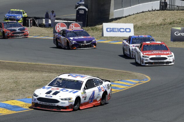 Kevin Harvick (4) leads through a turn during the NASCAR Sprint Cup Series auto race Sunday, June 25, 2017, in Sonoma, Calif. (AP Photo/Ben Margot)