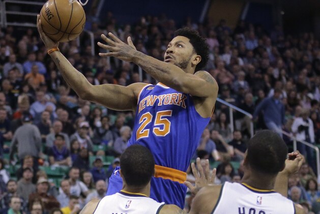 New York Knicks guard Derrick Rose (25) shoots as Utah Jazz's George Hill (3) and Rodney Hood (5) defend during the first half during an NBA basketball game Wednesday, March 22, 2017, in Salt Lake City. (AP Photo/Rick Bowmer)