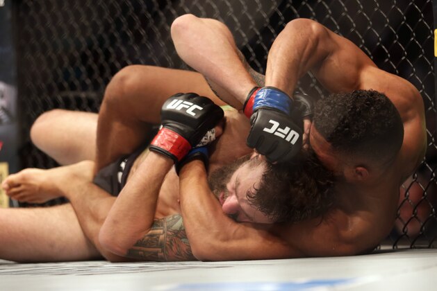 Jun 25, 2017; Oklahoma City, OK, USA; Michael Chiesa (red gloves) fights Kevin Lee (blue gloves) during UFC Fight Night at Chesapeake Energy Arena. Mandatory Credit: Sean Pokorny-USA TODAY Sports