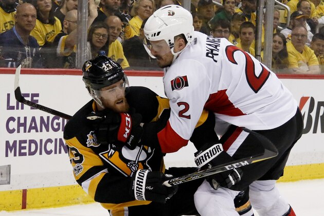 Pittsburgh Penguins' Scott Wilson (23) and Ottawa Senators' Dion Phaneuf (2) battle in the corner during the second period of Game 5 in the NHL hockey Stanley Cup Eastern Conference finals, Sunday, May 21, 2017, in Pittsburgh. (AP Photo/Gene J.Puskar)