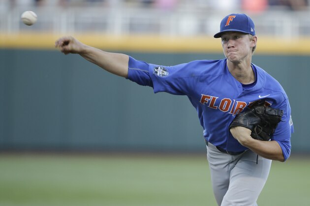 Florida pitcher Brady Singer works against Louisville during the seventh inning of an NCAA College World Series baseball game in Omaha, Neb., Tuesday, June 20, 2017. Florida won 5-1. (AP Photo/Nati Harnik)