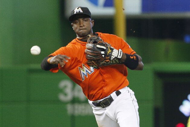 Miami Marlins shortstop Adeiny Hechavarria throws to first base to put out Chicago White Sox's Omar Narvaez during the fifth inning of a baseball game, Sunday, Aug. 14, 2016, in Miami. The Marlins defeated the White Sox 5-4. (AP Photo/Wilfredo Lee)