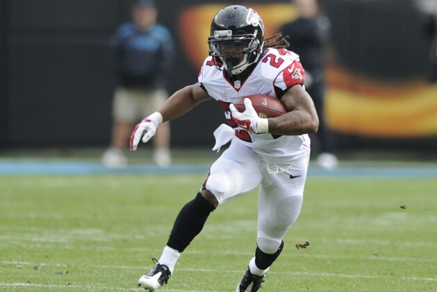 FILE - In this Dec. 24, 2016, file photo, Atlanta Falcons' Devonta Freeman (24) runs against the Carolina Panthers in the first half of an NFL football game in Charlotte, N.C. NFL teams ran the ball less than ever in 2016 yet six playoff teams had a 1,000-yard rusher. Ezekiel Elliot (Cowboys), Jay Ajayi (Dolphins), Le'Veon Bell (Steelers), LeGarrette Blount (Patriots), Devonta Freeman (Falcons) and Lamar Miller (Texans) each topped 1,000 and are still playing. Last year, Adrian Peterson was the only 1,000-yard rusher in the playoffs. (AP Photo/Mike McCarn, File)
