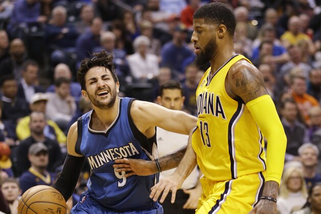 Minnesota Timberwolves guard Ricky Rubio (9) drives on Indiana Pacers forward Paul George (13) during the first half of an NBA basketball game in Indianapolis, Tuesday, March 28, 2017. (AP Photo/Michael Conroy)