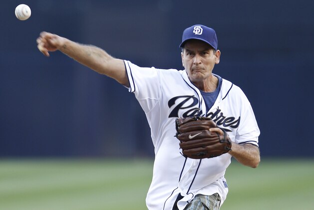 Entertainer Charlie Sheen throws out out the first pitch at the baseball game between the San Diego Padres and Cincinnati Reds, Saturday, July 7, 2012, in San Diego. (AP Photo/Lenny Ignelzi)