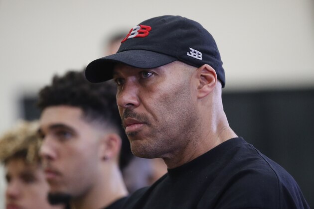 LaVar Ball, center, father of Los Angeles Lakers draft pick Lonzo Ball, listens to his son during a news conference, Friday, June 23, 2017, in El Segundo, Calif. (AP Photo/Jae C. Hong)