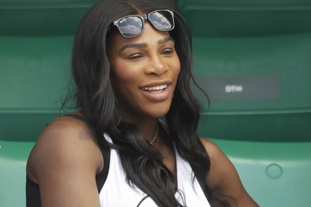 Serena Williams of the U.S., center, watches her sister Venus Williams' match against Japan's Kurumi Nara during their second round match of the French Open tennis tournament at the Roland Garros stadium, in Paris, France. Wednesday, May 31, 2017. (AP Photo/Petr David Josek)