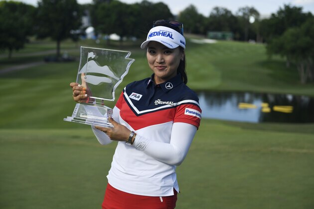 So Yeon Ryu, from South Korea, holds up her trophy for photographers after winning the LPGA Wal-Mart NW Arkansas Championship golf tournament at Pinnacle Country Club in Rogers, Ark., Sunday, June 25, 2017. (AP Photo/Michael Woods)