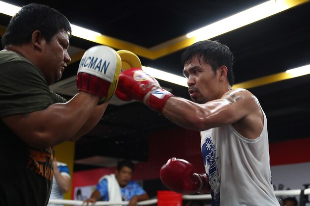 MANILA, PHILIPPINES - MAY 19:  Manny Pacquiao hits the pads with  Buboy Buboy Fernandez at Elorde boxing Gym on May 19, 2017 in Manila, Philippines.  (Photo by Chris Hyde/Getty Images)