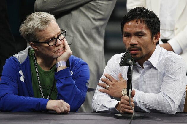 FILE - In this May 2, 2015 photo, trainer Freddie Roach, left, listens as Manny Pacquiao answers questions during a press conference following his welterweight title fight against Floyd Mayweather Jr. in Las Vegas. Pacquiao could face disciplinary action from Nevada boxing officials for failing to disclose a shoulder injury before the fight. Nevada Athletic Commission Chairman Francisco Aguilar said that the state attorney general’s office will look at why Pacquiao checked “no” a day before the fight on a commission questionnaire asking if he had a shoulder injury. (AP Photo/John Locher)