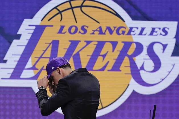 Lonzo Ball puts on a cap as he approaches the stage after being selected by the Los Angeles Lakers as the No. 2 pick overall during the NBA basketball draft, Thursday, June 22, 2017, in New York. (AP Photo/Frank Franklin II) Lonzo Ball puts on a cap as he approaches the stage after being selected by the Los Angeles Lakers as the No. 2 pick overall during the NBA basketball draft, Thursday, June 22, 2017, in New York. (AP Photo/Frank Franklin II)