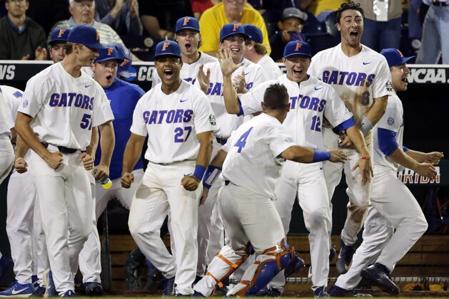 Florida players celebrate after two-run single against LSU during the eighth inning in Game 2 of the NCAA College World Series baseball finals in Omaha, Neb., Tuesday, June 27, 2017. (AP Photo/Nati Harnik)