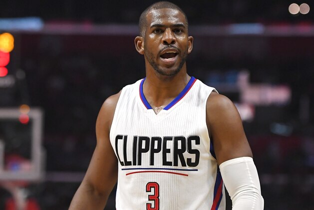 Los Angeles Clippers guard Chris Paul talks to his brother C.J. in the crowd during the first half of an NBA basketball game against the Washington Wizards, Wednesday, March 29, 2017, in Los Angeles. (AP Photo/Mark J. Terrill)
