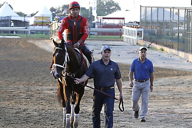 Preakness Stakes entrant Classic Empire, exercise rider Martin Rivera up,  is led from the track by assistant trainer Norman Casse at Pimlico Race Course in Baltimore, Friday, May 19, 2017. At far right is trainer Mark Casse. (AP Photo/Garry Jones)