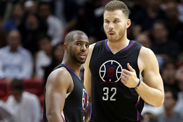 LA Clippers guard Chris Paul, left, talks with forward Blake Griffin (32) during the first half of an NBA basketball game against the Miami Heat, Friday, Dec. 16, 2016, in Miami. (AP Photo/Lynne Sladky)
