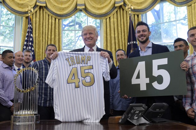 President Donald Trump holds up a Chicago Cubs jersey and Cubs third baseman Kris Bryant holds a