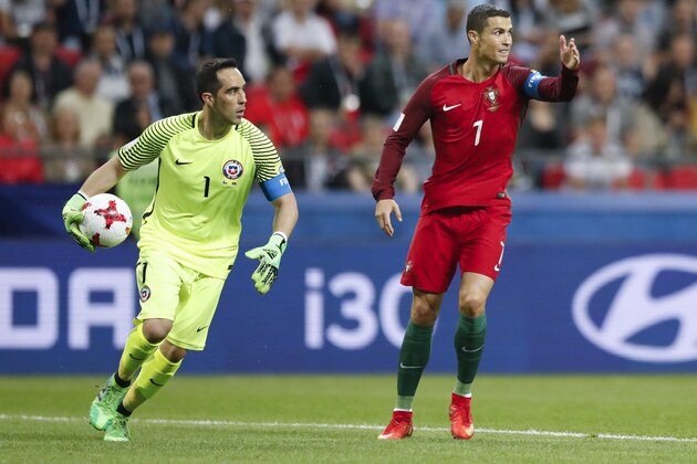 Portugal's Cristiano Ronaldo, right, gestures next to Chile goalkeeper Claudio Bravo during the Confederations Cup, semifinal soccer match between Portugal and Chile, at the Kazan Arena, Russia, Wednesday, June 28, 2017. (AP Photo/Pavel Golovkin)