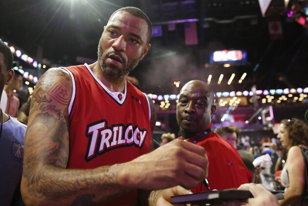 Trilogy's player/captain Kenyon Martin, left, looks up as fans shout for his autograph leaving the court after he played in Game 4 in the BIG3 Basketball League's debut, Sunday, June 25, 2017, at the Barclays Center in New York. (AP Photo/Kathy Willens)