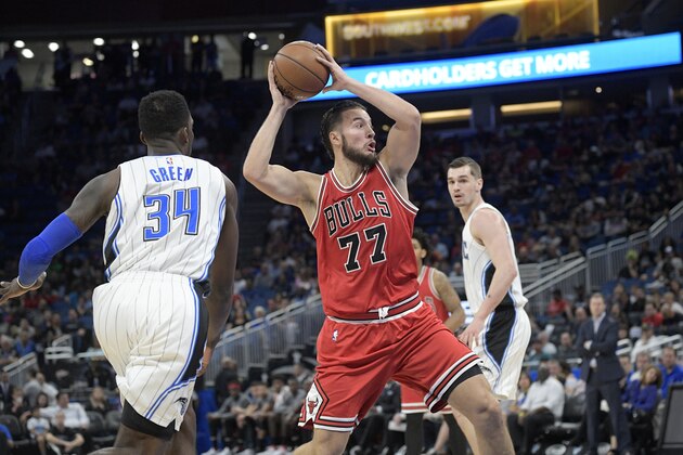 Chicago Bulls center Joffrey Lauvergne (77) drives to the basket between Orlando Magic forward Jeff Green (34) and guard Mario Hezonja (8), right, during the first half of an NBA basketball game in Orlando, Fla., Wednesday, March 8, 2017. (AP Photo/Phelan M. Ebenhack)