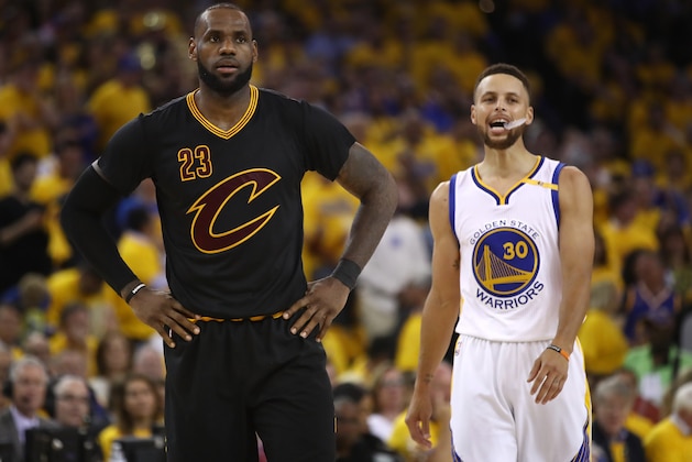 OAKLAND, CA - JUNE 12: LeBron James #23 of the Cleveland Cavaliers and Stephen Curry #30 of the Golden State Warriors look on during the first half in Game 5 of the 2017 NBA Finals at ORACLE Arena on June 12, 2017 in Oakland, California. NOTE TO USER: User expressly acknowledges and agrees that, by downloading and or using this photograph, User is consenting to the terms and conditions of the Getty Images License Agreement.  (Photo by Ezra Shaw/Getty Images)