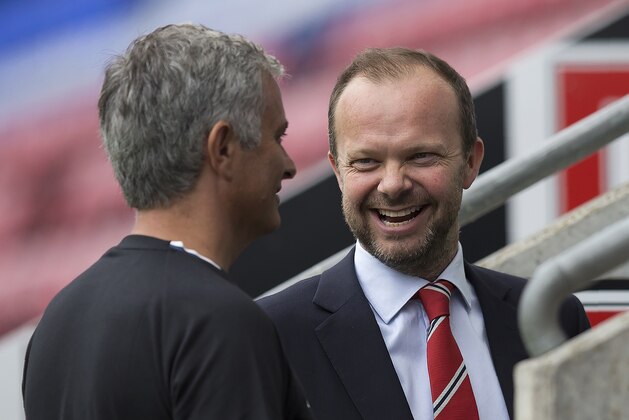 Manchester United's executive vice-chairman Ed Woodward (R) reacts as he talks with Manchester United's Portuguese manager Jose Mourinho folowing the pre-season friendly football match between Wigan Athletic and Manchester United at the DW stadium in Wigan, northwest England, on July 16, 2016.  / AFP / JON SUPER / RESTRICTED TO EDITORIAL USE. No use with unauthorized audio, video, data, fixture lists, club/league logos or 'live' services. Online in-match use limited to 75 images, no video emulation. No use in betting, games or single club/league/player publications.  /         (Photo credit should read JON SUPER/AFP/Getty Images)