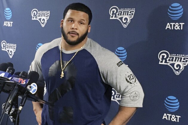 FILE - This April 10, 2017 file photo shows Los Angeles Rams defensive lineman Aaron Donald speaking with reporters after the first official day of the team's offseason football training program in Thousand Oaks, Calif. Donald has skipped the Los Angeles Rams’ first day of organized team activities while he negotiates a long-term contract extension with the club. (AP Photo/Greg Beacham, file)