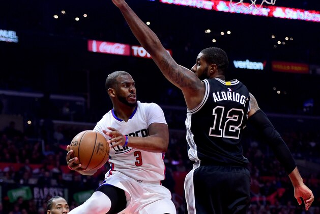 LOS ANGELES, CA - FEBRUARY 24:  Chris Paul #3 of the LA Clippers makes a pass around LaMarcus Aldridge #12 of the San Antonio Spurs during the first half at Staples Center on February 24, 2017 in Los Angeles, California.  NOTE TO USER: User expressly acknowledges and agrees that, by downloading and or using this photograph, User is consenting to the terms and conditions of the Getty Images License Agreement.  (Photo by Harry How/Getty Images)