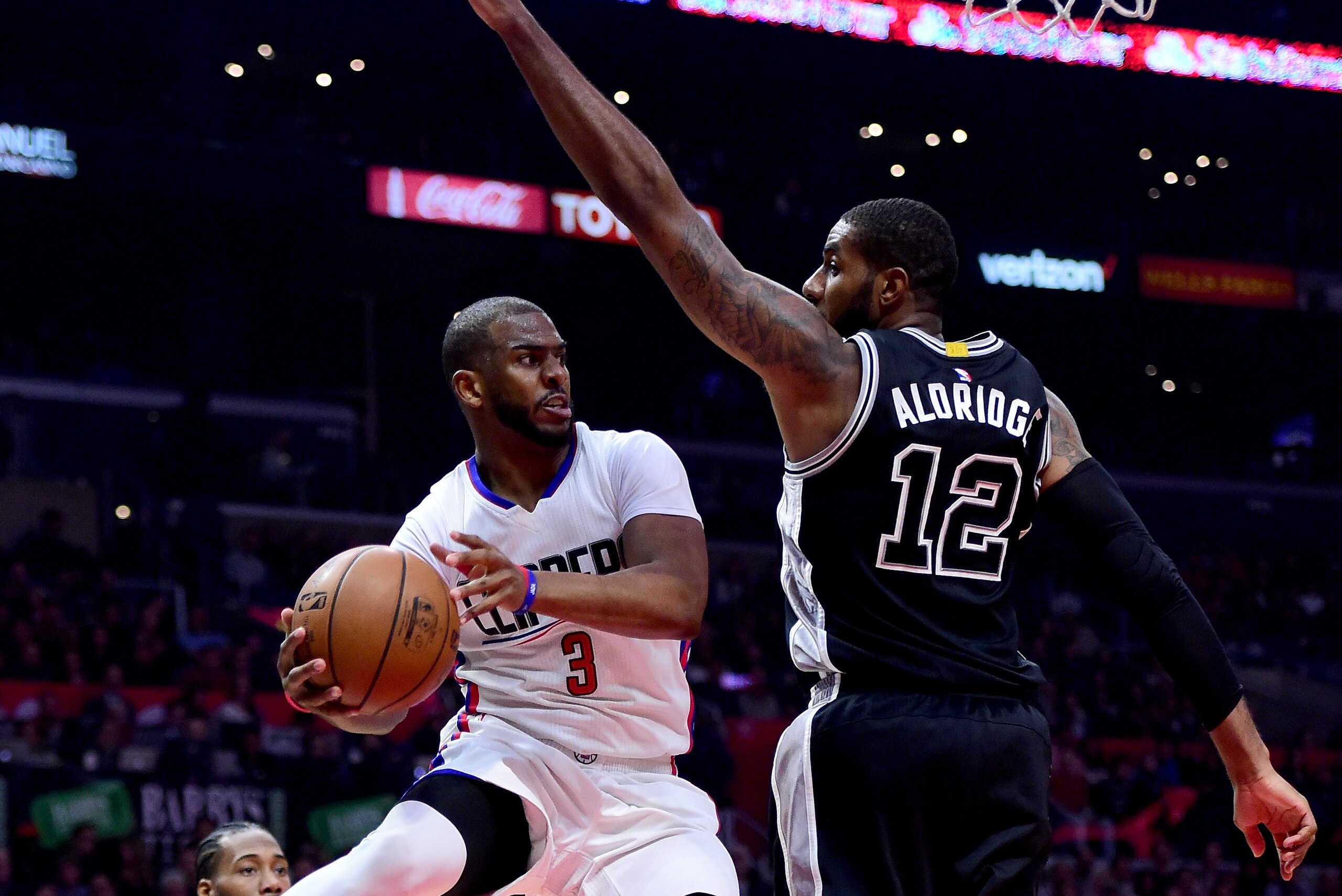LOS ANGELES, CA - FEBRUARY 24:  Chris Paul #3 of the LA Clippers makes a pass around LaMarcus Aldridge #12 of the San Antonio Spurs during the first half at Staples Center on February 24, 2017 in Los Angeles, California.  NOTE TO USER: User expressly acknowledges and agrees that, by downloading and or using this photograph, User is consenting to the terms and conditions of the Getty Images License Agreement.  (Photo by Harry How/Getty Images)