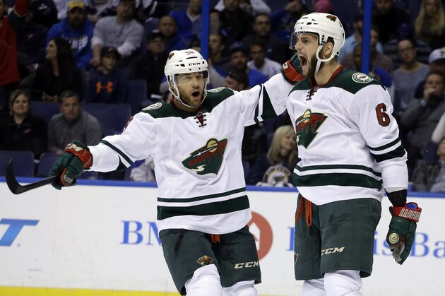 Minnesota Wild's Marco Scandella, right, is congratulated by teammate Jason Pominville after scoring during the first period in Game 5 of an NHL hockey first-round playoff series against the St. Louis Blues, Friday, April 24, 2015, in St. Louis. (AP Photo/Jeff Roberson)