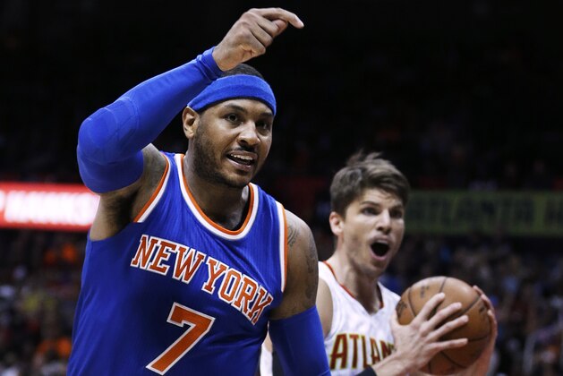 New York Knicks' Carmelo Anthony, left, calls for a foul as Atlanta Hawks' Kyle Korver, right, reacts to the referee's call in favor of Anthony during the fourth quarter of an NBA basketball game Saturday, Dec. 26, 2015, in Atlanta. (AP Photo/David Goldman)