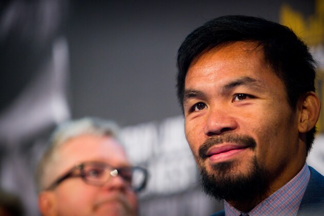 Philippine boxer Manny Pacquiao (R) and trainer Freddie Roach attend a press conference to promote Pacquiao's WBO Welterweight title fight against Australian challenger Jeff Horn at Suncorp Stadium in Brisbane on June 28, 2017. 
Manny Pacquiao's world title fight with Jeff Horn will be 'short and sweet' with a knockout likely, his trainer predicted on June 28, as his Australian challenger said he was 'ready for war'.  / AFP PHOTO / Patrick HAMILTON / -- IMAGE RESTRICTED TO EDITORIAL USE - STRICTLY NO COMMERCIAL USE --        (Photo credit should read PATRICK HAMILTON/AFP/Getty Images)