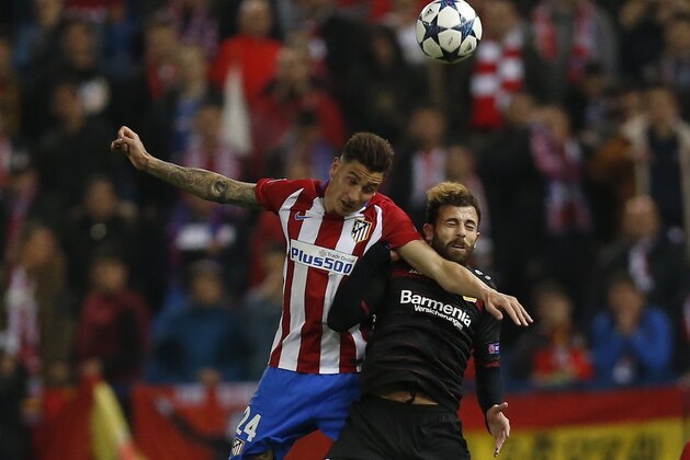 Atletico's Jose Maria Gimenez, left is airborne with Leverkusen's Admir Mehmedi during the Champions League round of 16 second leg soccer match between Atletico Madrid and Bayer Leverkusen at the Vicente Calderon stadium in Madrid, Spain, Wednesday, March 15, 2017. (AP Photo/Daniel Ochoa de Olza)
