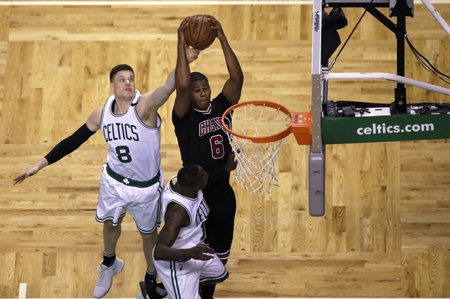 Boston Celtics forward Jonas Jerebko (8) tries to strip the ball from the grip of Chicago Bulls forward Cristiano Felicio (6) during the fourth quarter of a first-round NBA playoff basketball game in Boston, Wednesday, April 26, 2017. The Celtics defeated the Bulls 108-97. (AP Photo/Charles Krupa)