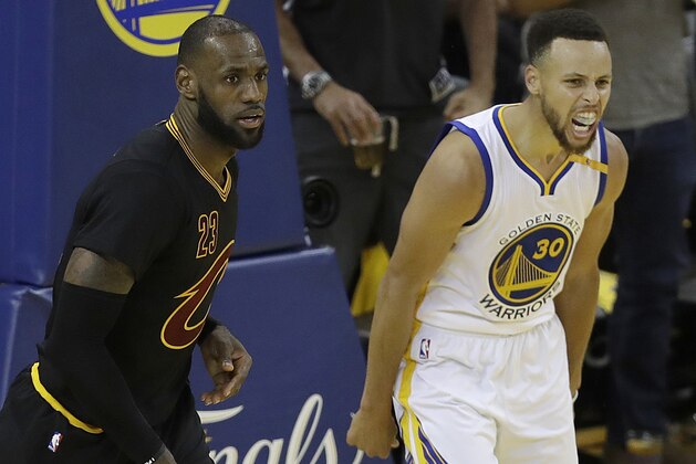 Golden State Warriors guard Stephen Curry (30) reacts after scoring next to Cleveland Cavaliers forward LeBron James during the second half of Game 2 of basketball's NBA Finals in Oakland, Calif., Sunday, June 4, 2017. (AP Photo/Marcio Jose Sanchez)