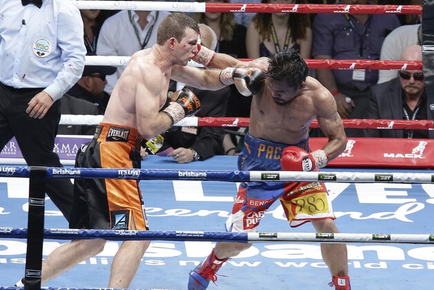 Jeff Horn of Australia, left, and Manny Pacquiao of the Philippines, right, lands a left to during their WBO World Welterweight title fight in Brisbane, Australia, Sunday, July 2, 2017.  Pacquiao lost his WBO welterweight world title to Horn in a stunning, unanimous points decision in a Sunday afternoon bout billed as the Battle of Brisbane in front of more than 50,000 people.(AP Photo/Tertius Pickard)