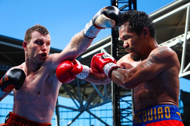Manny Pacquiao (R) of the Philippines fight Jeff Horn (L) of Australia during the World Boxing Organization boat at Suncorp Stadium in Brisbane on July 1, 2017.  / AFP PHOTO / Patrick HAMILTON / -- IMAGE RESTRICTED TO EDITORIAL USE - STRICTLY NO COMMERCIAL USE --        (Photo credit should read PATRICK HAMILTON/AFP/Getty Images)