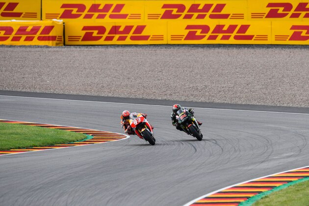 Spanish Honda rider Marc Marquez (L) and German Yamaha rider Jonas Folger compete during the MotoGP competition of the Moto Grand Prix of Germany at the Sachsenring Circuit on July 2, 2017 in Hohenstein-Ernstthal, eastern Germany.  / AFP PHOTO / ROBERT MICHAEL        (Photo credit should read ROBERT MICHAEL/AFP/Getty Images)