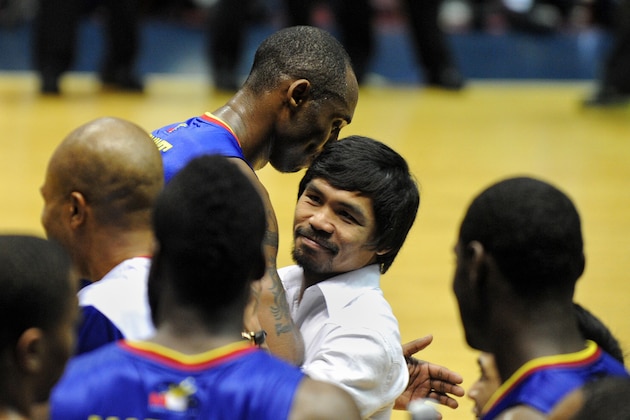 Philippine boxing champion and Congressman Manny Pacquiao (centre R) speaks to Kobe Bryant (centre L) of the Los Angeles Lakers as he visits an exhibition game between visiting National Basketball Association players and a team of top players from the Philippines for the Ultimate All-Star Weekend at the Araneta Coliseum in suburban Manila on July 24, 2011. The proceeds from the exibition game will help Philippine sports and develop Filipino athletes into becoming world-class competitors.   AFP PHOTO / NOEL CELIS (Photo credit should read NOEL CELIS/AFP/Getty Images)
