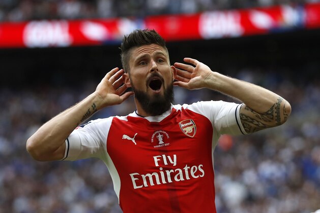Arsenal's Olivier Giroud celebrates after Aaron Ramsey scored their side's second goal during the English FA Cup final soccer match between Arsenal and Chelsea at Wembley stadium in London, Saturday, May 27, 2017. (AP Photo/Kirsty Wigglesworth)