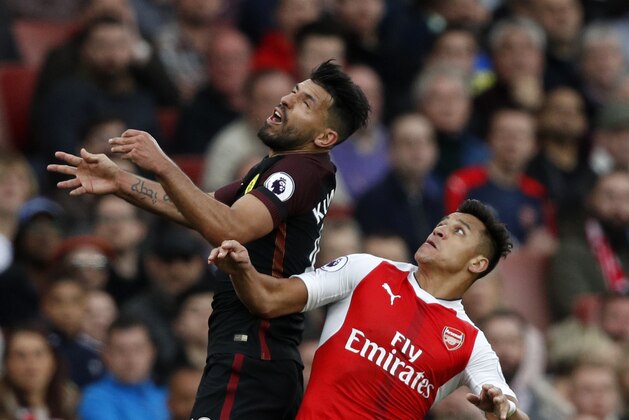 Manchester City's Argentinian striker Sergio Aguero (L) vies with Arsenal's Chilean striker Alexis Sanchez during the English Premier League football match between Arsenal and Manchester City at the Emirates Stadium in London on April 2, 2017. 
The game finished 2-2. / AFP PHOTO / Adrian DENNIS / RESTRICTED TO EDITORIAL USE. No use with unauthorized audio, video, data, fixture lists, club/league logos or 'live' services. Online in-match use limited to 75 images, no video emulation. No use in betting, games or single club/league/player publications.  /         (Photo credit should read ADRIAN DENNIS/AFP/Getty Images)