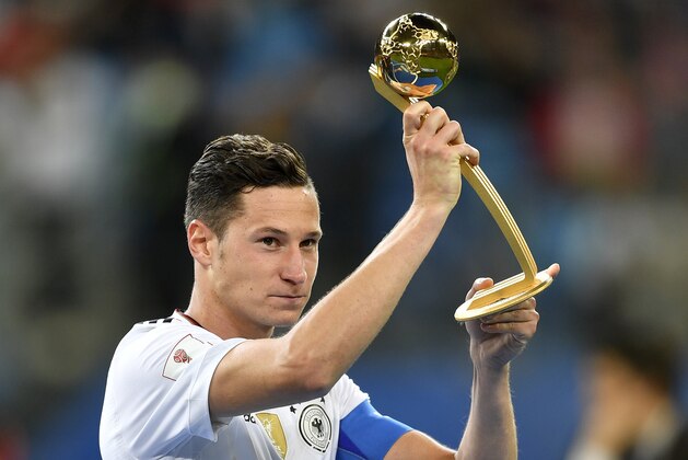 Germany's Julian Draxler holds the Golden Ball best player award after Germany won 1-0 in the Confederations Cup final soccer match between Chile and Germany, at the St.Petersburg Stadium, Russia, Sunday July 2, 2017. (AP Photo/Martin Meissner)
