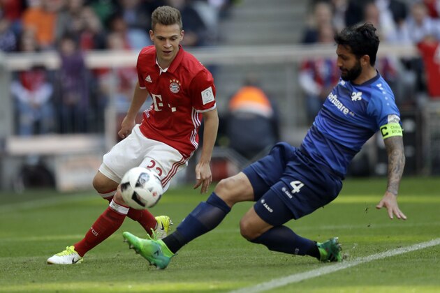 Bayern's Joshua Kimmich, left, and Darmstadt's Aytac Sulu challenge for the ball during the German Soccer Bundesliga match between FC Bayern Munich and SV Darmstadt 98 at the Allianz Arena stadium in Munich, Germany, Saturday, May 6, 2017. (AP Photo/Matthias Schrader)